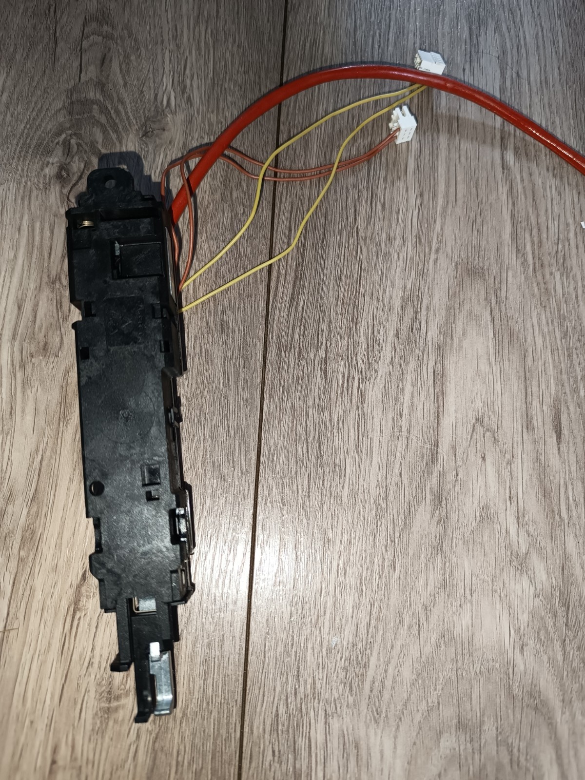 s-l1600-1004.jpg Black electrical switch module with red and yellow wires and white connector headers resting on a wooden floor, shown from the side.
