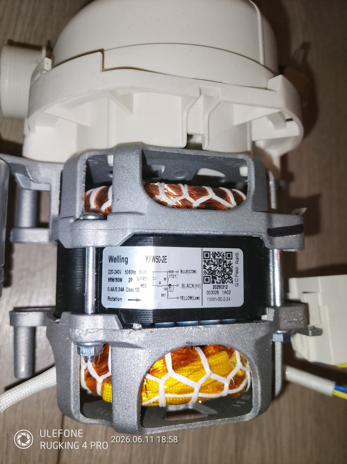 s-l1600-1079.jpg Close-up of a small electric motor with visible copper windings and a gray housing, and a label showing model YW50-2E and technical details on its side.