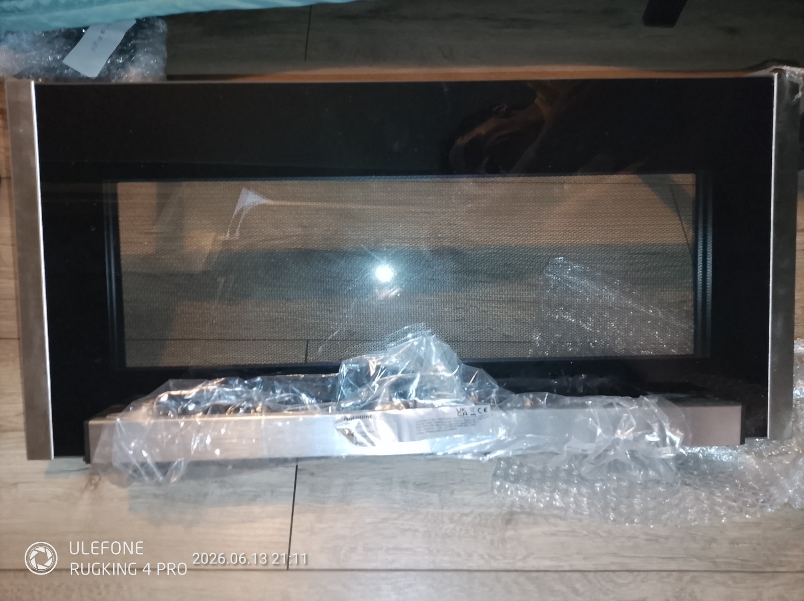s-l1600-1139.jpg Brand-new stainless steel microwave oven with a black glass door, partially wrapped in plastic on a wooden floor.