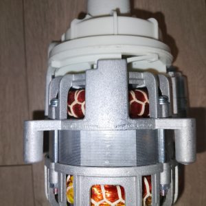 Close-up of an electric motor rotor with white plastic mounting and exposed copper windings