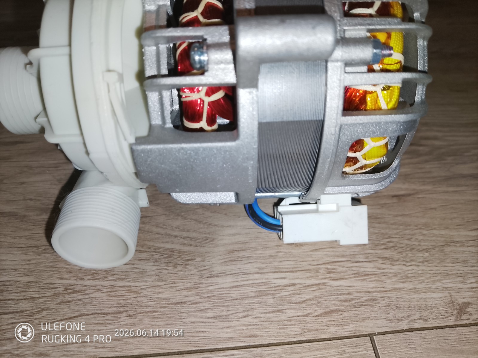 s-l1600-1148.jpg Internal view of an electric motor with copper windings and a white plastic hose connector on the left; blue and black wires exit a white connector at the bottom.