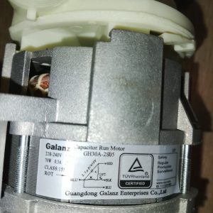 Close-up of a white plastic component and gray electric motor with a label showing 220-240V and 70W, part of an appliance motor assembly