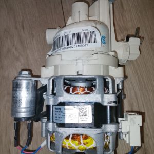 Electrical pump and motor assembly with white plastic housing, barcode label, and visible copper windings in the metal frame.