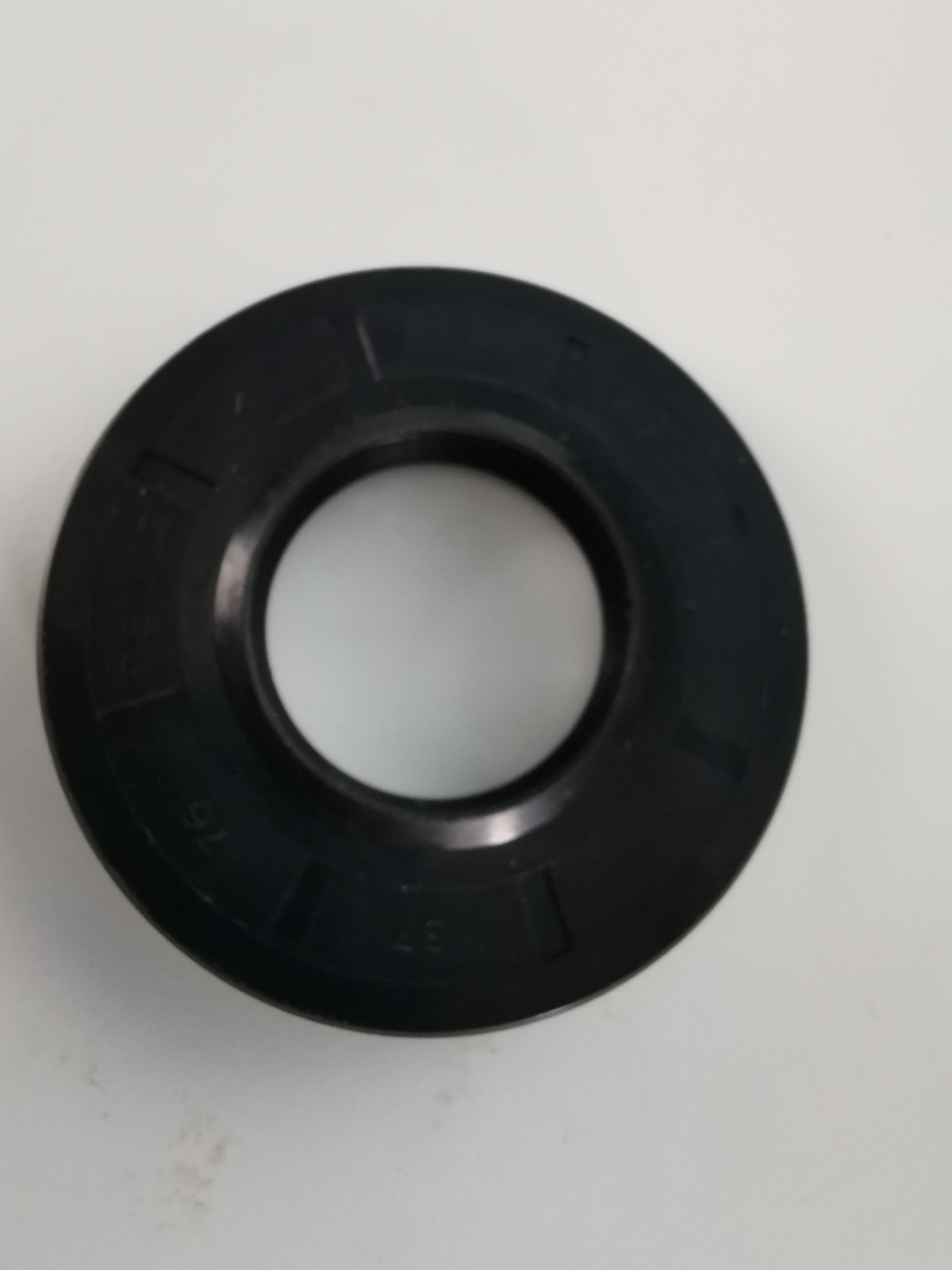 s-l1600-1170.jpg Black circular gasket with a hollow center on a light background, resembling a washer or seal