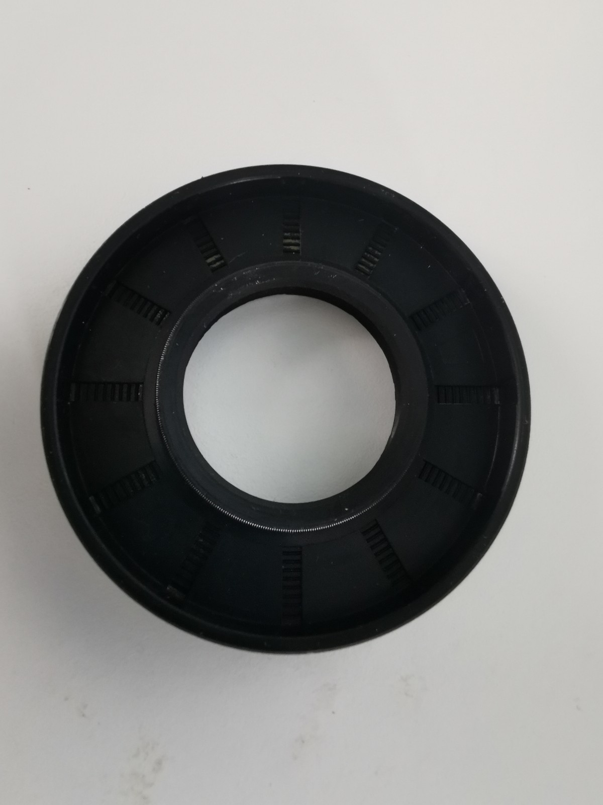 s-l1600-1171.jpg Black circular plastic ring with a central bore and evenly spaced rectangular slots around the inner circumference.