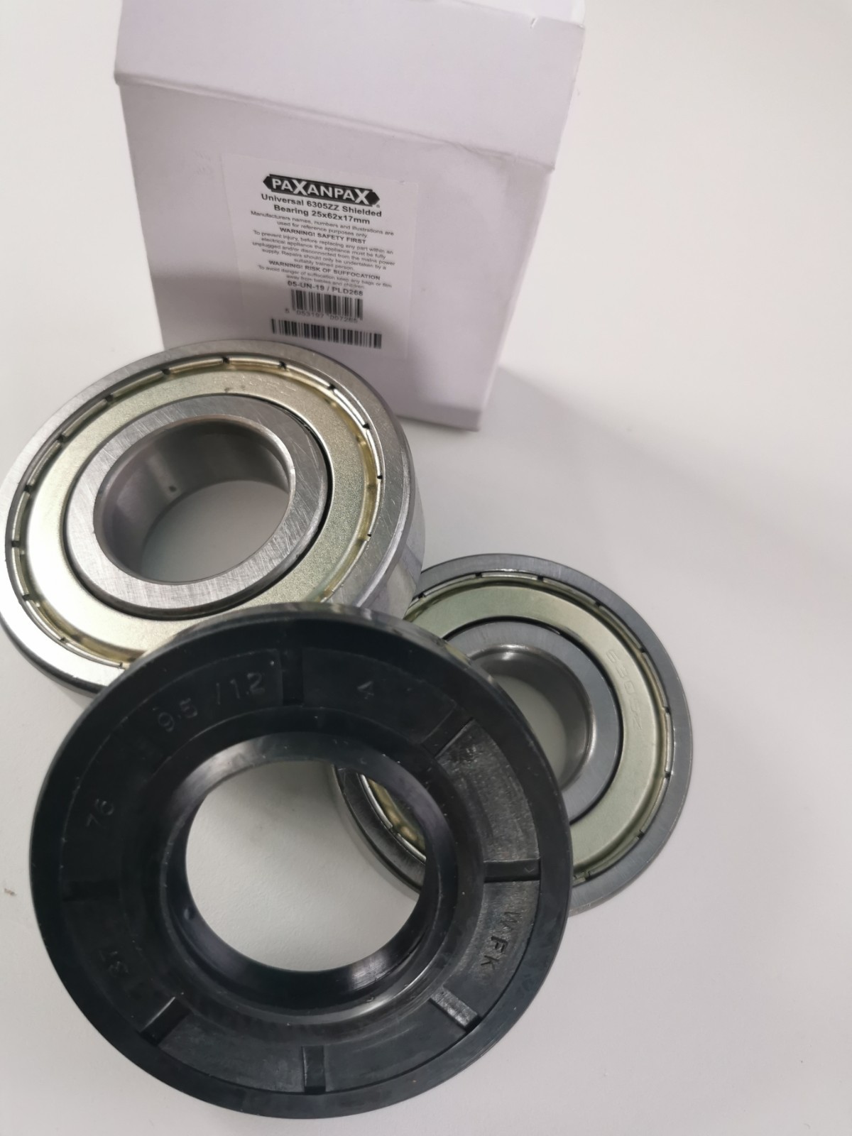 s-l1600-1173.jpg Close-up of ball bearings and seals on a white surface with a white box in the background (PAXANPAX label).