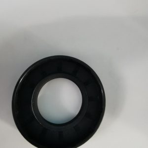 Black circular rubber gasket (O-ring) with inner hole, laid on a white surface.