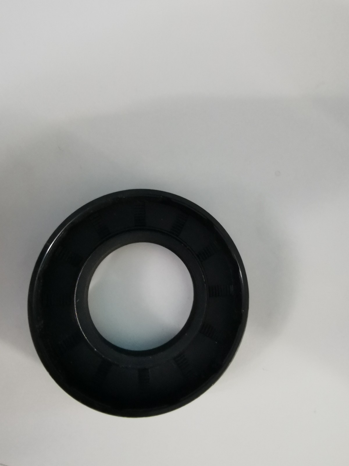 s-l1600-1175.jpg Black circular rubber gasket (O-ring) with inner hole, laid on a white surface.