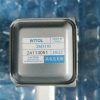 Metallic electronic component with blue-printed label: WITOL, Made in China, model 2M319J, serial 24113051, D622, and a high-voltage microwave radiation caution label (including Chinese text).