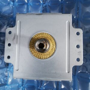 Square metal mounting plate with a central threaded hole surrounded by a gold textured ring, on blue bubble wrap.