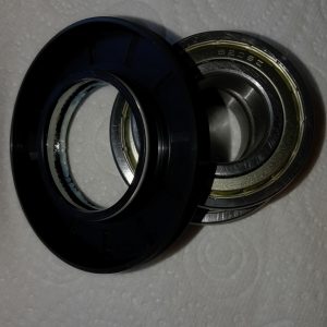 Close-up of two circular camera lens adapters stacked together on a textured white background.