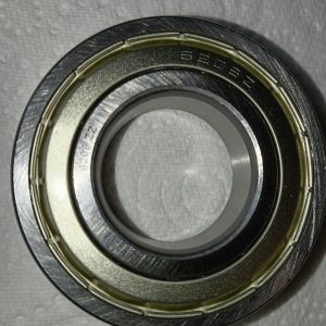 Close-up of a metal ball bearing race: concentric inner and outer rings with a recessed center.