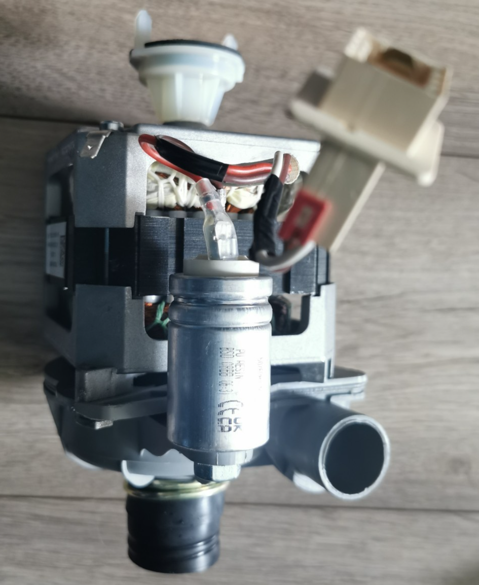 s-l1600-14.png Disassembled appliance pump with motor, wires, and white plastic fittings