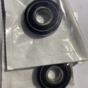 Close-up of two sealed ball bearings in a plastic-wrapped metal housing.