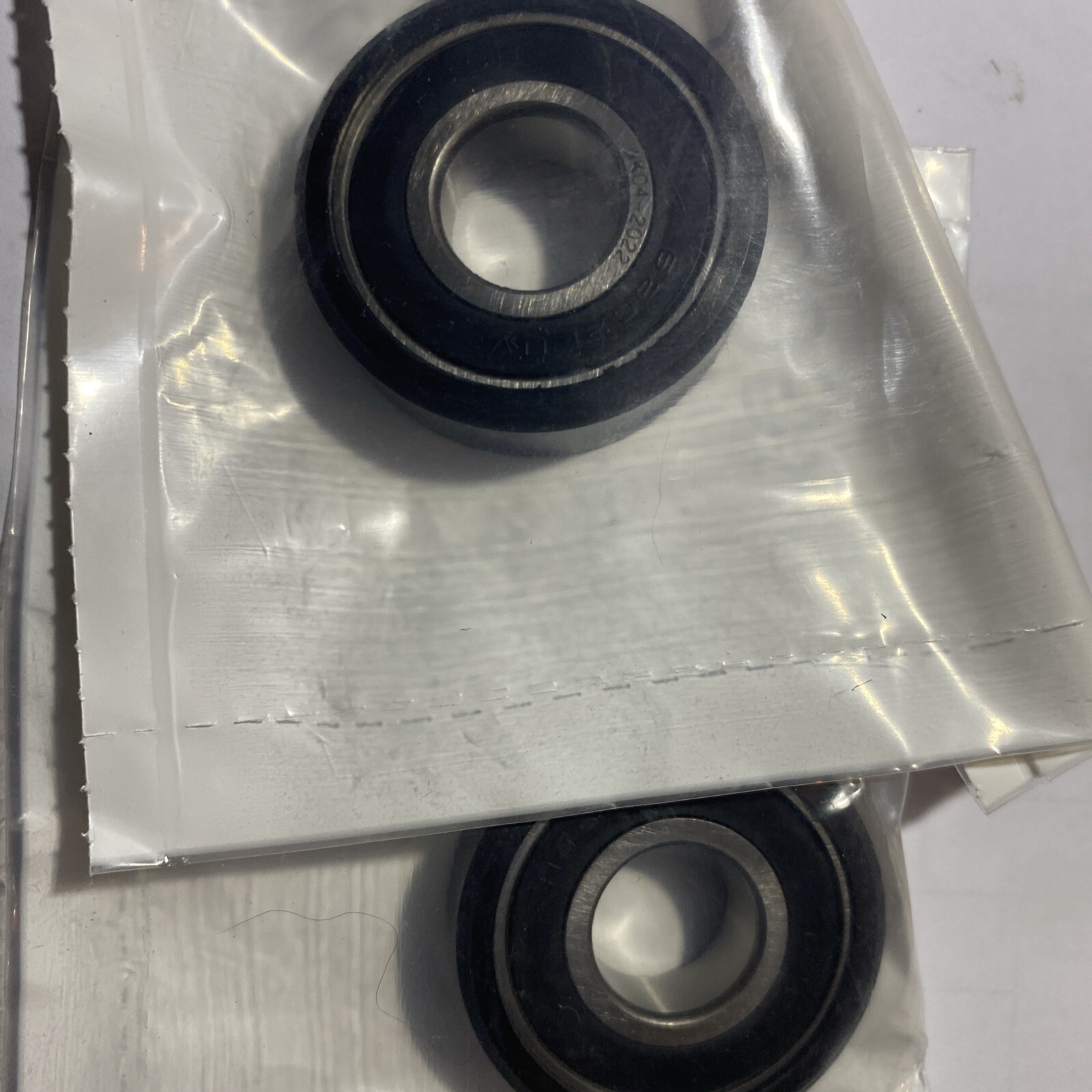 s-l1600-147.jpg Close-up of two sealed ball bearings in a plastic-wrapped metal housing.