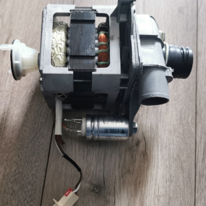 Electrical motor assembly with copper windings and plastic housing on a wooden floor