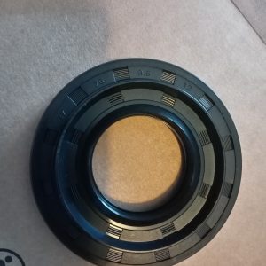 Close-up of a black circular camera lens part with numbered graduations and grooves around the edge, likely an aperture or focus ring.