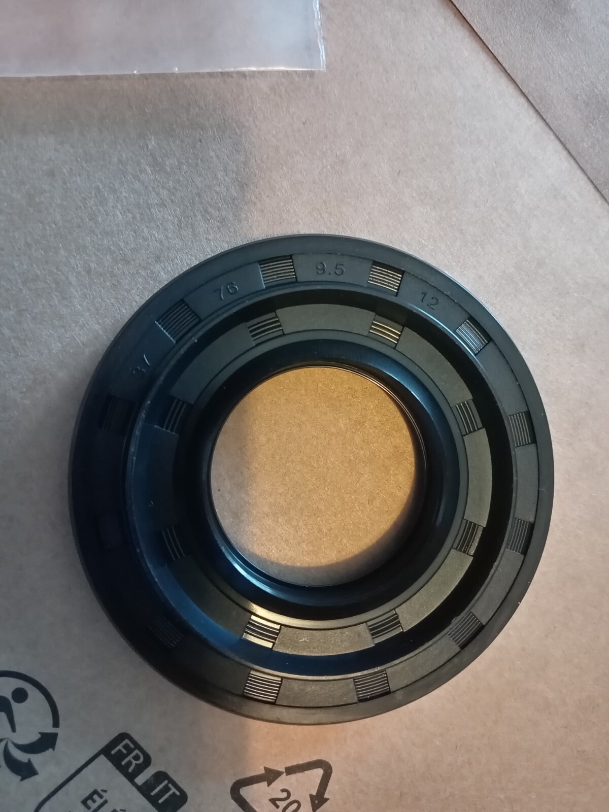 s-l1600-150.jpg Close-up of a black circular camera lens part with numbered graduations and grooves around the edge, likely an aperture or focus ring.