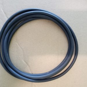 Coiled black rubber electrical cable on a brown cardboard background in a neat circle