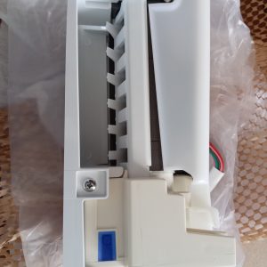 White plastic electrical module with a row of small vertical slots and a blue toggle/button on the lower left, wires visible on the right side