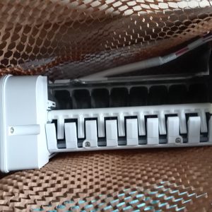 White row of circuit breakers with multiple toggle levers inside a protective cardboard mesh wrap in a packaging box.