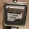 Metal high-voltage transformer in a metal case with the label 'WITOL 2M518J' and a microwave radiation warning.