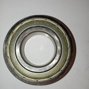 Close-up of a metal ball bearing showing the outer ring, inner race, and bearing cage.