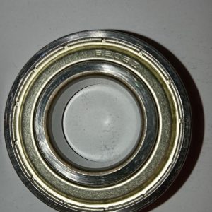 Close-up of a metal ball bearing race with inner and outer rings, no balls visible.