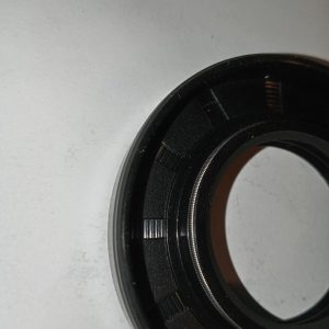 Close-up of the rear of a black camera lens showing the mount with bayonet lugs and a metal ring.