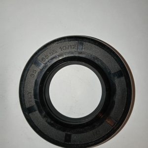 Black circular oil seal or gasket with an inner ring, laid on a white surface; features engraved markings such as '10/12' and '65' along its outer edge.