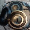Close-up of metal wheel bearing components (inner and outer races) inside a clear plastic bag, showing a seal and rings of metal.