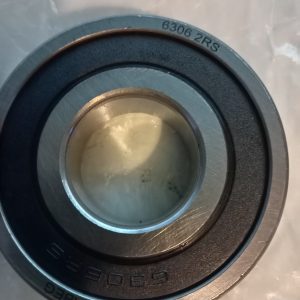 Close-up of a metal bearing with inner and outer races, stamped '6306 2RS' on the outer ring.