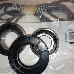 Plastic bag containing several black metal seal rings/bearings stacked together with a barcode label visible on the white packaging behind them.