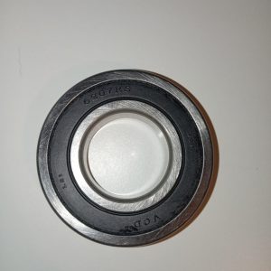 Close-up of a round metal ball bearing showing inner and outer races, with '6207RS' engraved on the outer ring.