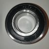 Close-up of a metal bearing race with a brushed inner surface and outer ring photographed at an angle