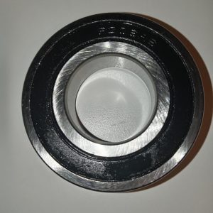 Close-up of a metal bearing race with a brushed inner surface and outer ring photographed at an angle