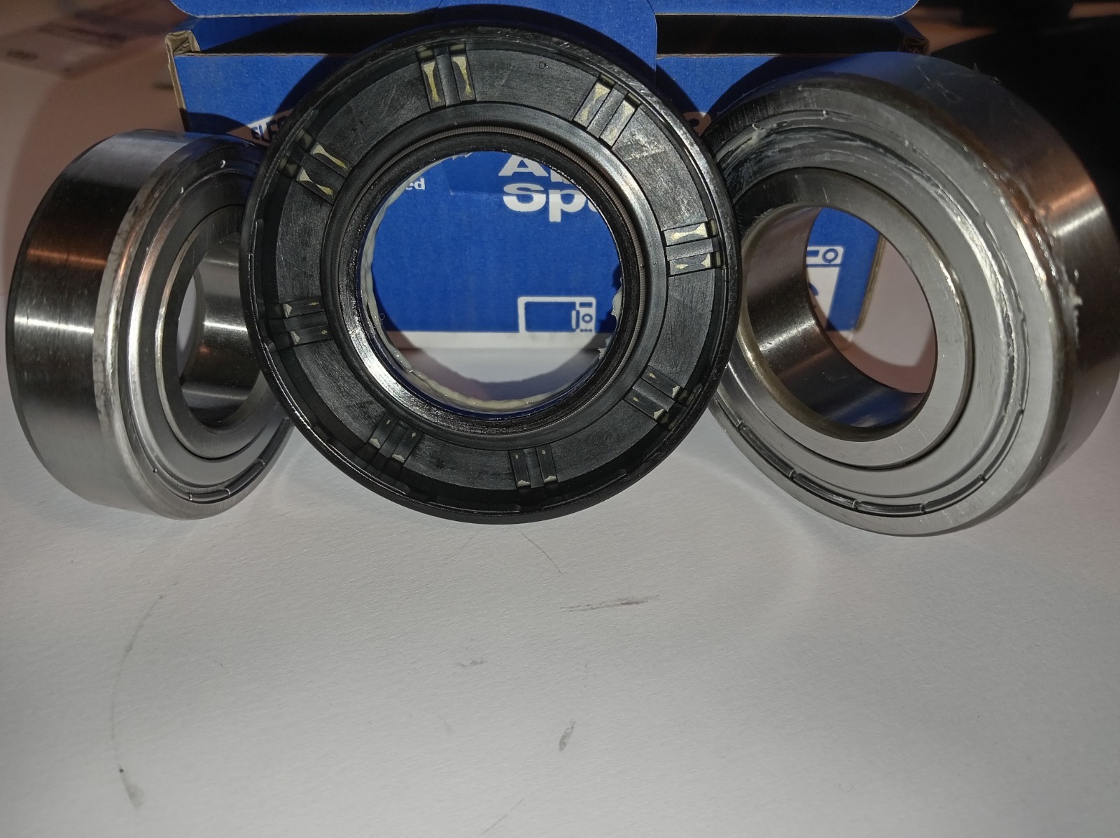 s-l1600-317.jpg Three bearings (two metal, one black plastic) arranged in a row with a blue box behind them for scale and storage.