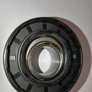 Close-up of a metal bearing assembly with black outer ring and inner silver race, showing grooves and the label ABEC ER on the inner ring area.