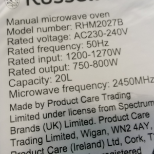 Label on a microwave showing model RHM2027B, 20L capacity and electrical specs (230–240V, 50Hz, 1200–1270W input, 750–800W output) with brand details.