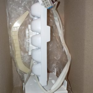 White plastic multi-bulb light fixture with four rounded lamp housings, packed in a cardboard box, showing its wiring harness and a beige mounting piece nearby.