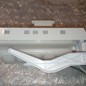White plastic appliance component with a long rectangular body on bubble wrap, incl. an angled support arm.