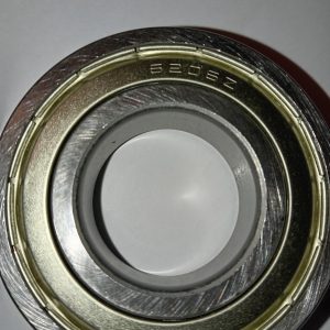 Close-up of a metal ball bearing with inner and outer rings; stamped code 6206Z on the outer race.