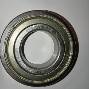 Close-up of a metal ball bearing showing inner and outer race rings.