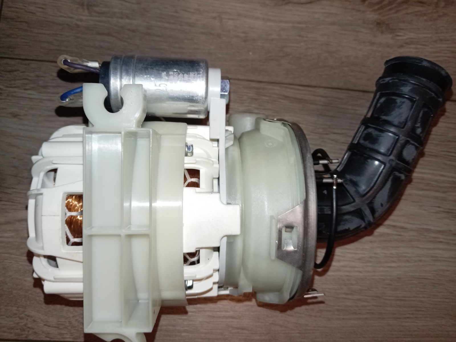 s-l1600-395.jpg Internal view of a small automotive blower motor with white plastic housing, copper windings, and a curved black duct attached at the side.