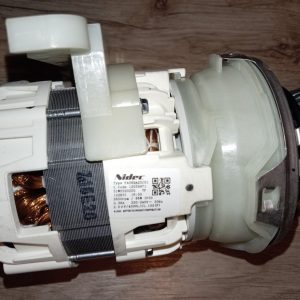 Electric motor assembly with copper windings and white plastic housing, labeled Nidec (close-up).