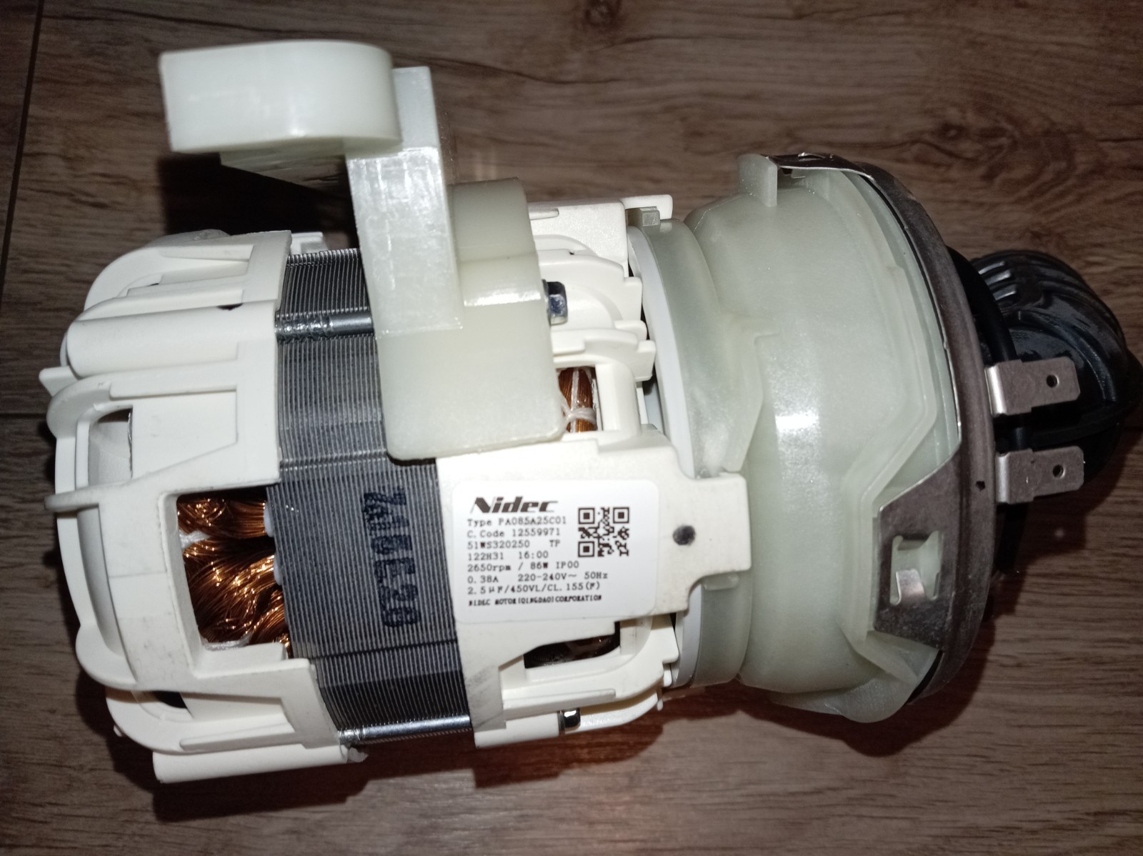 s-l1600-396.jpg Electric motor assembly with copper windings and white plastic housing, labeled Nidec (close-up).