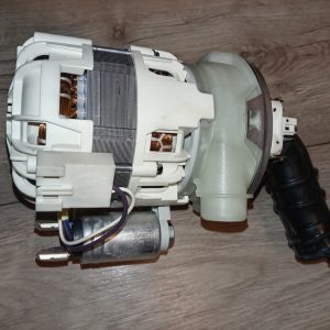 Disassembled car blower motor showing copper windings and white plastic housing on a wooden surface.