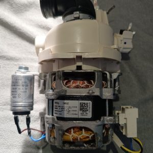 Disassembled electric motor module with copper windings, gray plastic housing, and attached wiring