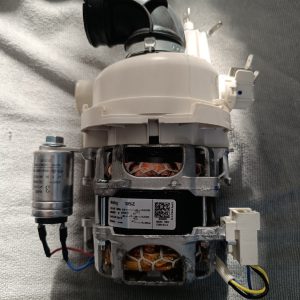 Electrical motor assembly with exposed copper windings and a gray capacitor attached to the side.