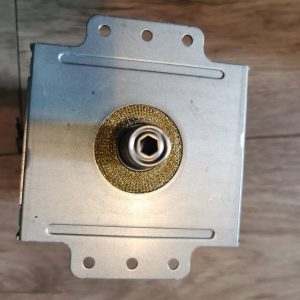 Metal rectangular electronic component with a round brass-textured bearing and a central hex bore shaft. Has mounting flanges on top and bottom edges.